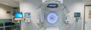 Modern hospital examination room with advanced medical imaging equipment, illustrating the role of AI in healthcare and patient outcomes.