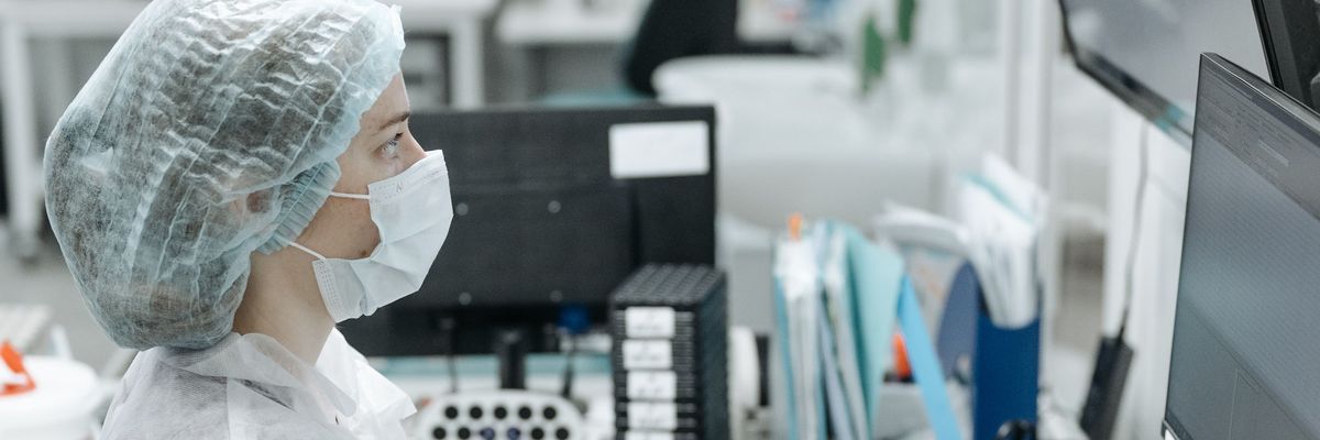 Healthcare professional reviewing clinical information on a computer as part of an AI driven healthcare initiative.