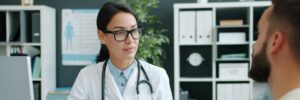 HCP consulting with a patient while using AI assisted medical documentation and reporting tools.