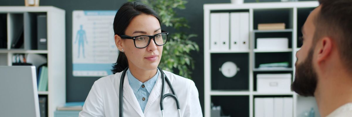 HCP consulting with a patient while using AI assisted medical documentation and reporting tools.
